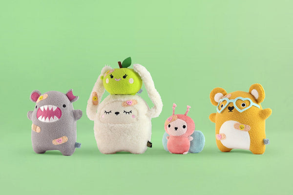 sustainable toys and recycled plush toys on green background