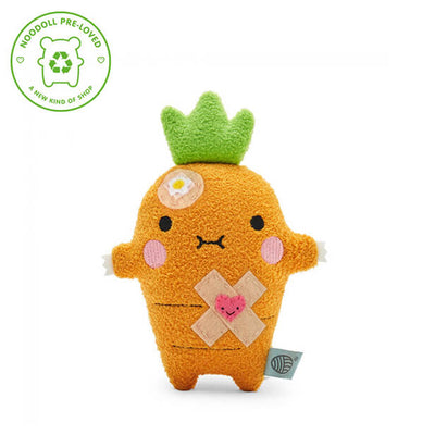 Plush toy with a green crown and bandage on a white background